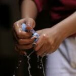 28-Hands squeezing a wash rag Thirteen (13) Ways Home Care Can Help Seniors Stay Safe at Home during the Pandemic