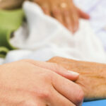 30-Compassionate Hands over bed 3 Caring Nurse Holding Hands